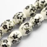 Porcelán ékszergyöngy. 12x10mm. Fekete virág. 