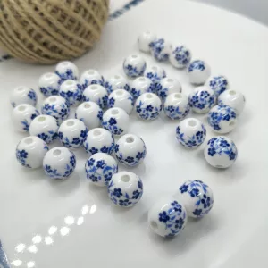 Porcelán gyöngy. 6mm. Sötétkék virágok.
