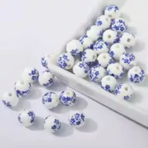 Porcelán ékszer gyöngy. 10mm. Világoskék apró virág.