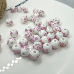 Porcelán gyöngy. 6mm. Rózsaszín virágok.